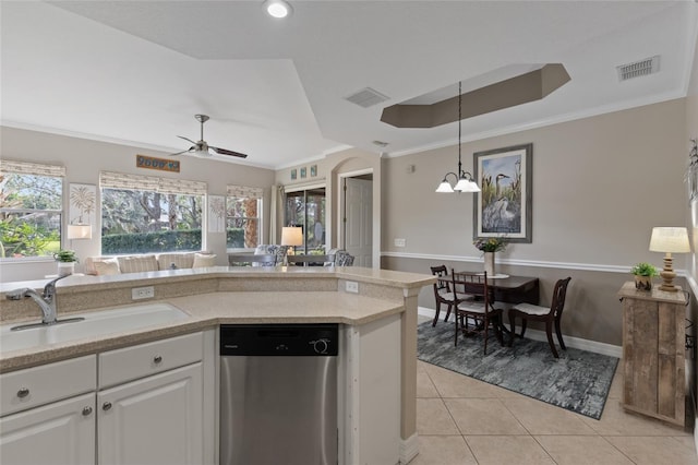 kitchen featuring white cabinets, ornamental molding, ceiling fan with notable chandelier, sink, and dishwasher