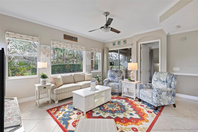 living room with light tile patterned floors, ceiling fan, and crown molding