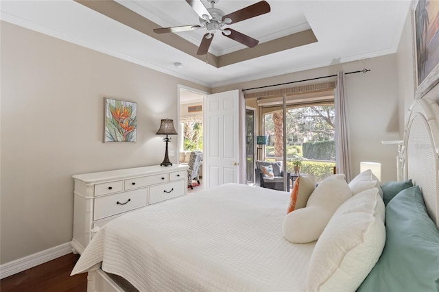 bedroom featuring ceiling fan, a raised ceiling, dark hardwood / wood-style floors, access to outside, and ornamental molding