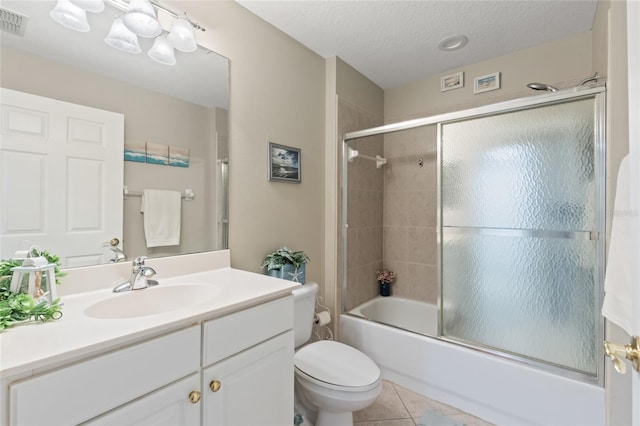 full bathroom featuring combined bath / shower with glass door, a textured ceiling, vanity, tile patterned flooring, and toilet