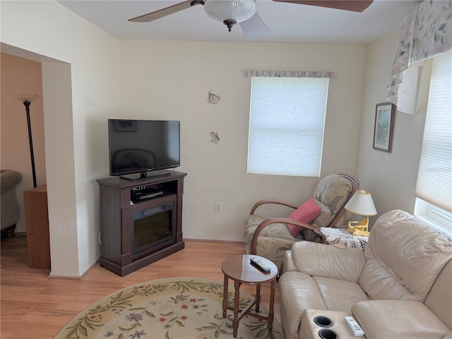 living room featuring ceiling fan and light wood-type flooring