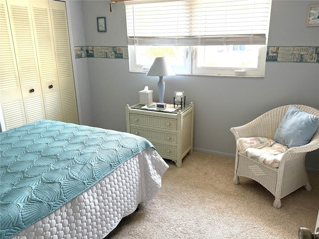 bedroom featuring light colored carpet and a closet