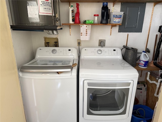 clothes washing area featuring electric panel and independent washer and dryer