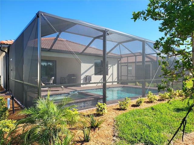 rear view of house with a patio and glass enclosure