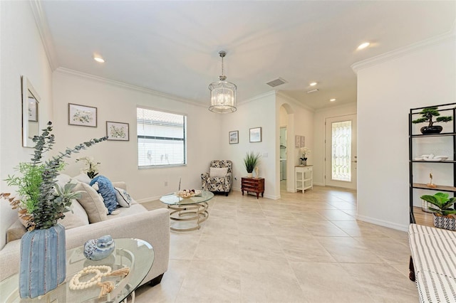 tiled living room with crown molding and a chandelier