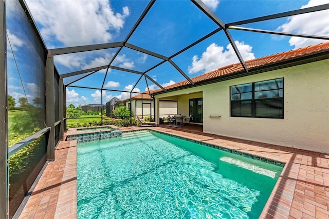 view of pool with an in ground hot tub, a patio area, and a lanai