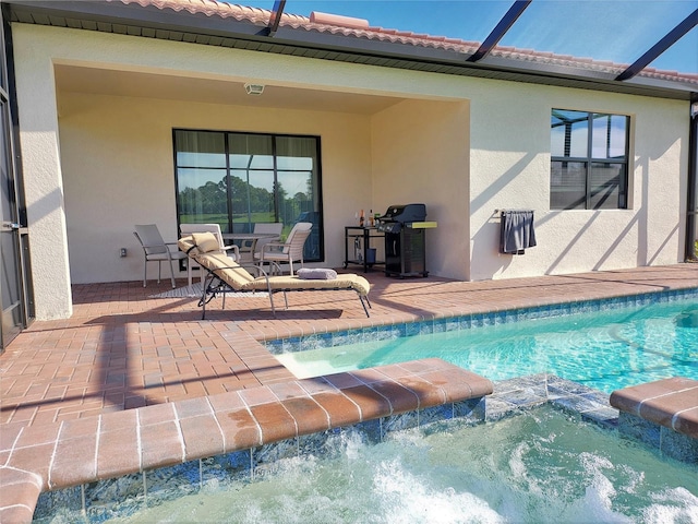 view of pool featuring a lanai, an in ground hot tub, and a patio