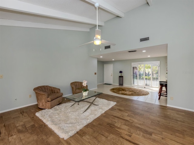 living room with ceiling fan, hardwood / wood-style floors, and lofted ceiling with beams