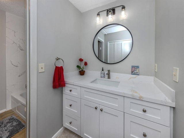 bathroom with a textured ceiling and vanity