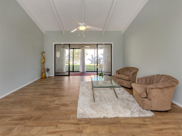 living room featuring light wood-type flooring, ceiling fan, and vaulted ceiling with beams