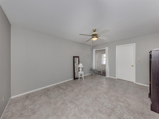 spare room with ceiling fan and a textured ceiling