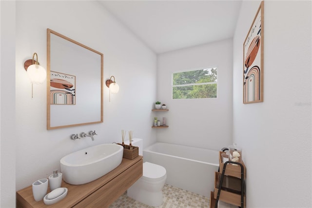 bathroom featuring sink, a bathtub, and toilet