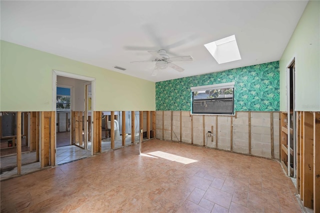 spare room with a skylight and ceiling fan