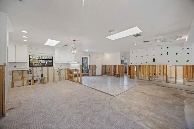 misc room featuring ceiling fan with notable chandelier and light tile patterned floors