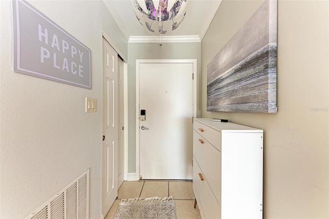 entryway with light tile patterned floors and ornamental molding