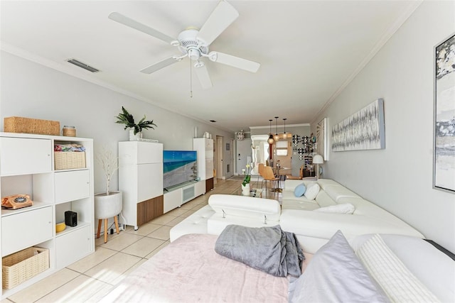 tiled living room with ceiling fan and ornamental molding