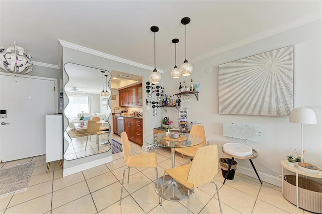 dining room featuring crown molding and light tile patterned floors