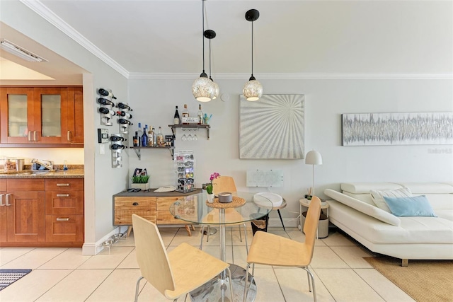 tiled dining area with crown molding and sink