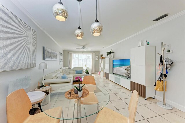 living room with light tile patterned floors, lofted ceiling, ceiling fan, and ornamental molding