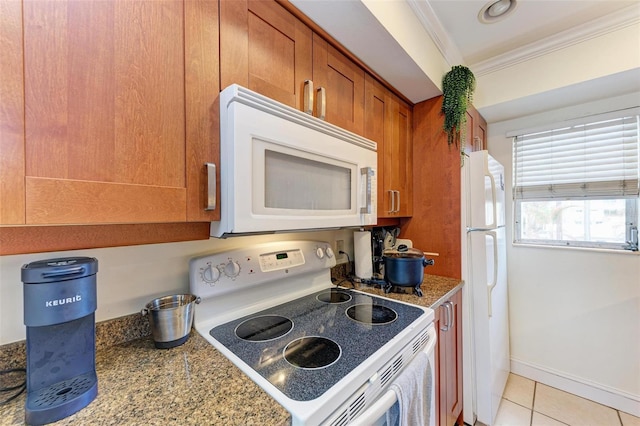 kitchen with crown molding, light tile patterned floors, light stone countertops, and white appliances