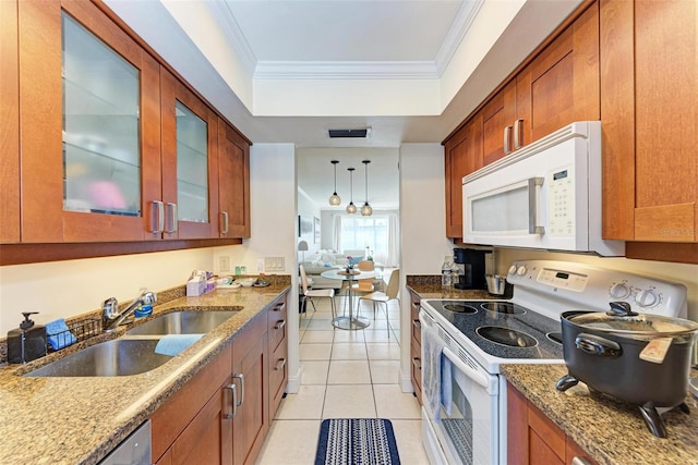 kitchen with sink, crown molding, decorative light fixtures, white appliances, and light tile patterned floors