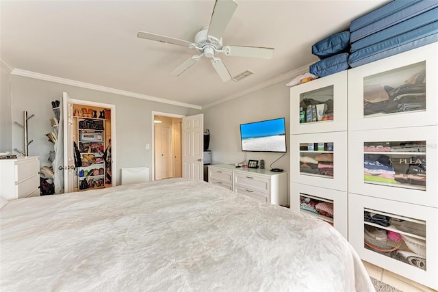 bedroom with ceiling fan, ornamental molding, and a closet