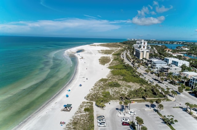 aerial view with a water view and a beach view