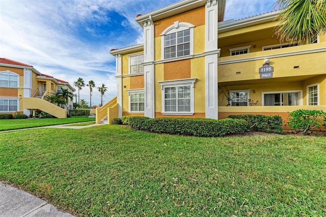 1195 Villagio Cir Unit 201, Sarasota, FL 34237 - view of home's exterior with stucco siding and a lawn