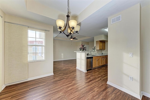 kitchen featuring dishwasher, sink, hanging light fixtures, dark hardwood / wood-style flooring, and kitchen peninsula