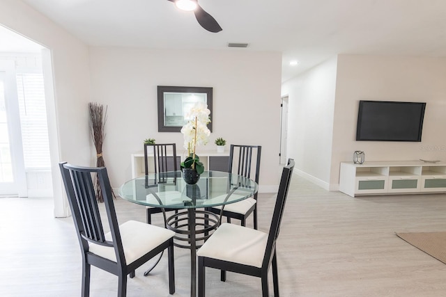 dining area featuring ceiling fan and light wood-type flooring