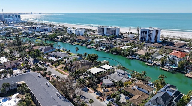 drone / aerial view featuring a water view and a beach view