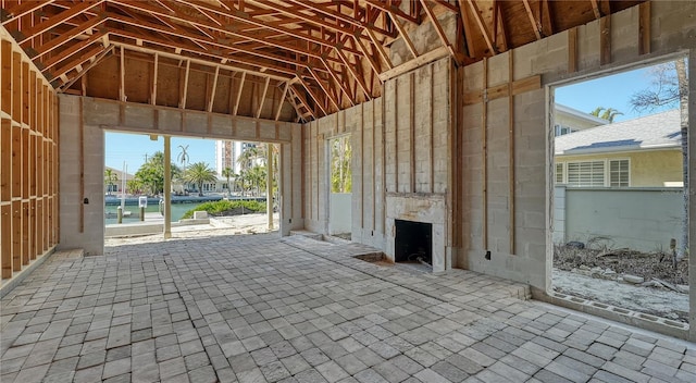 misc room featuring a high ceiling and exterior fireplace