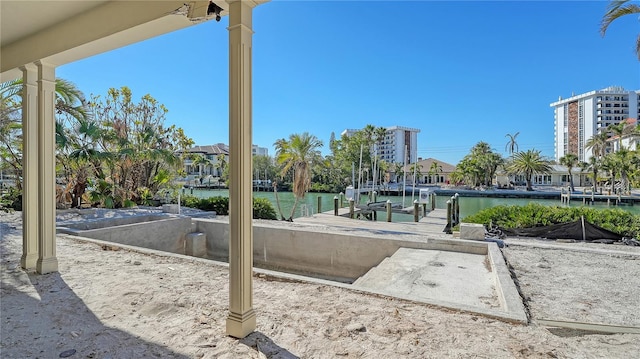 view of home's community featuring a water view and a dock