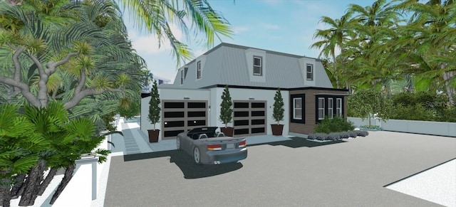 rear view of house featuring a garage