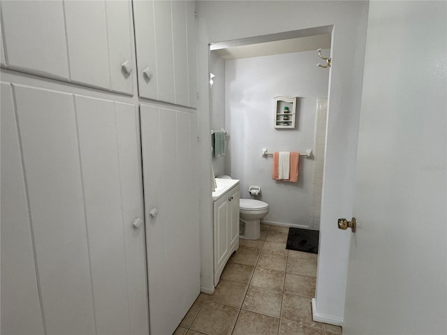 bathroom with vanity, tile patterned floors, and toilet