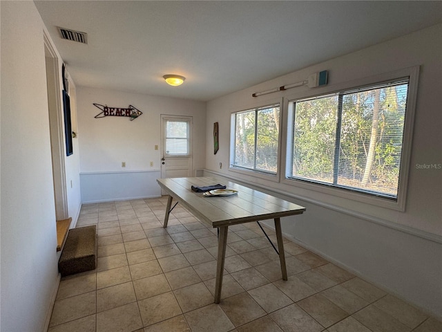 unfurnished dining area featuring light tile patterned flooring