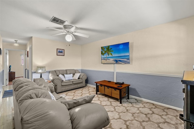 carpeted living room featuring ceiling fan