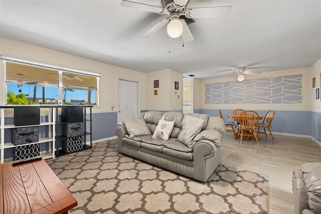 living room with light hardwood / wood-style flooring and ceiling fan