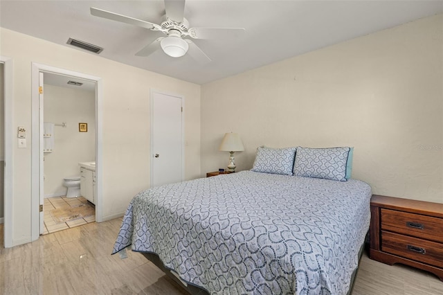 bedroom featuring ceiling fan, light hardwood / wood-style flooring, and ensuite bathroom