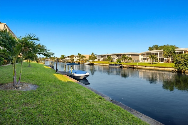 dock area featuring a lawn and a water view