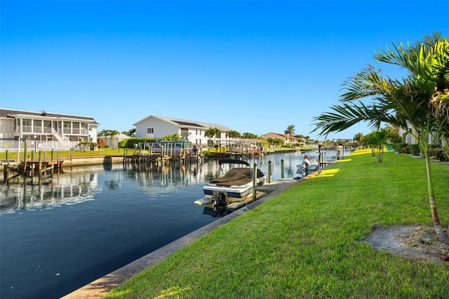 dock area featuring a water view and a lawn