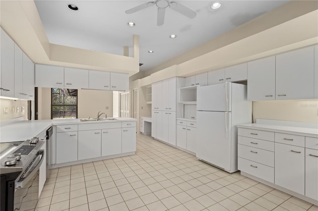 kitchen featuring ceiling fan, sink, white refrigerator, white cabinets, and stainless steel electric range oven