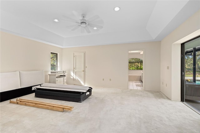 bedroom featuring access to exterior, connected bathroom, carpet floors, and multiple windows