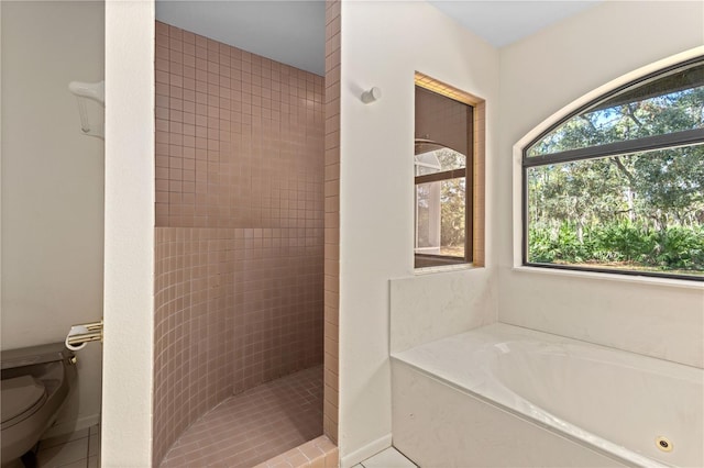 bathroom featuring tile patterned flooring, toilet, and independent shower and bath