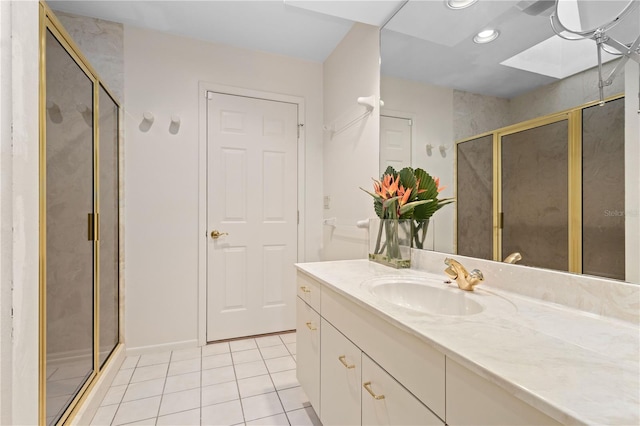 bathroom featuring tile patterned floors, vanity, and a shower with shower door