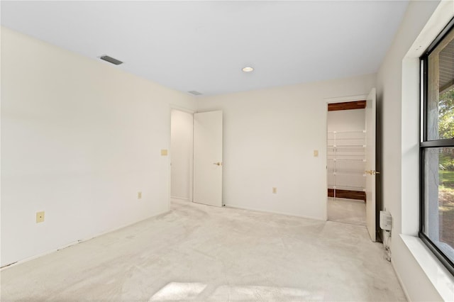 unfurnished room featuring light colored carpet