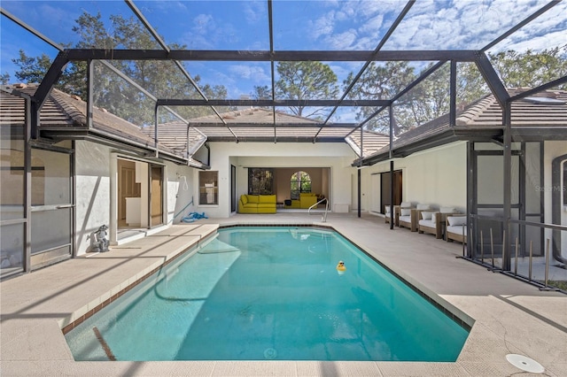 view of swimming pool featuring glass enclosure and a patio area