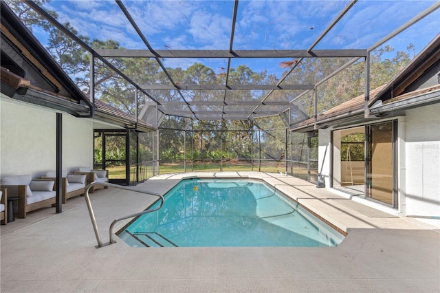 view of pool featuring glass enclosure and a patio area