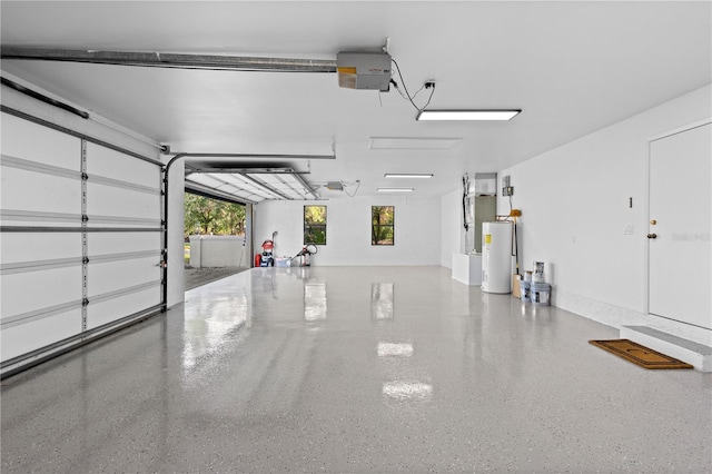 garage with electric water heater and a garage door opener