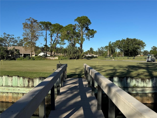 view of dock with a lawn